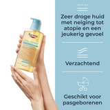 Eucerin AtopiControl bad- en doucheolie in een glazen fles met pomp, geschikt voor droge en jeukende huid.
